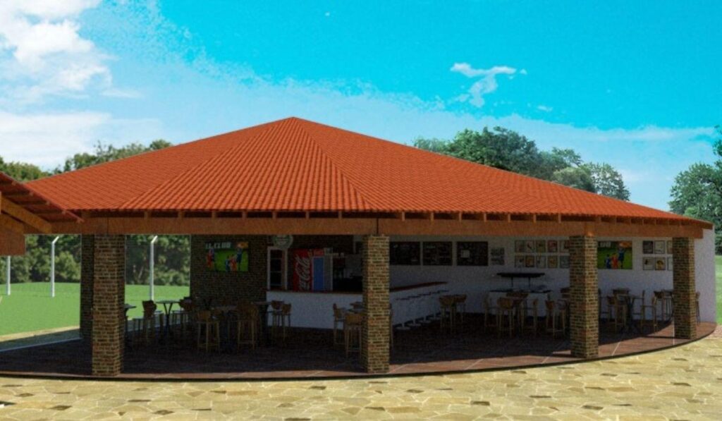 Tipos de telhas PVC: colonial ou plan, qual a melhor para o seu projeto? 1 Quiosque gourmet com ampla cobertura de telha de PVC colonial PERMATTI em tom cerâmica. Estrutura aberta com pilares de tijolos, ideal para áreas de lazer e clubes.